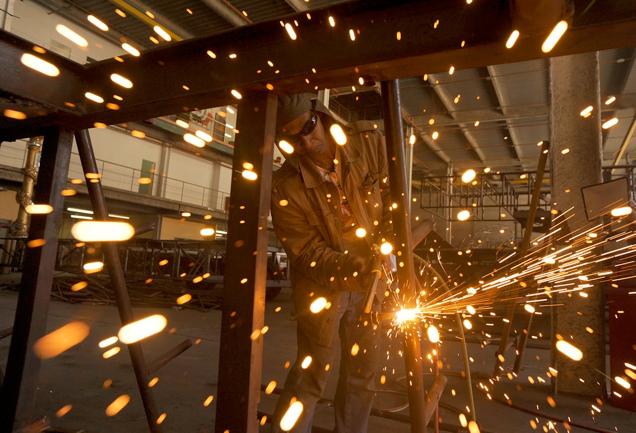 A welder sparks in an industrial workshop in Rio de Janeiro, Brazil.